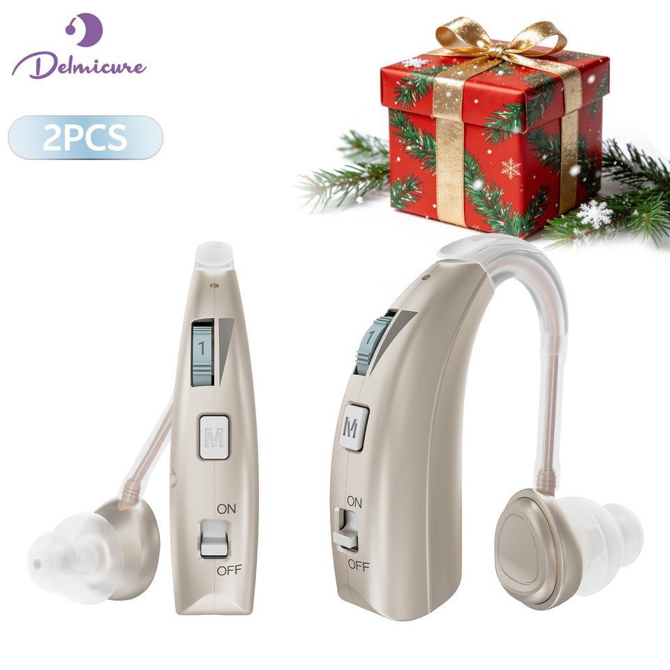 Two gold Delmicure VHP-1303 hearing aids with clear sound tubes and silicone ear domes